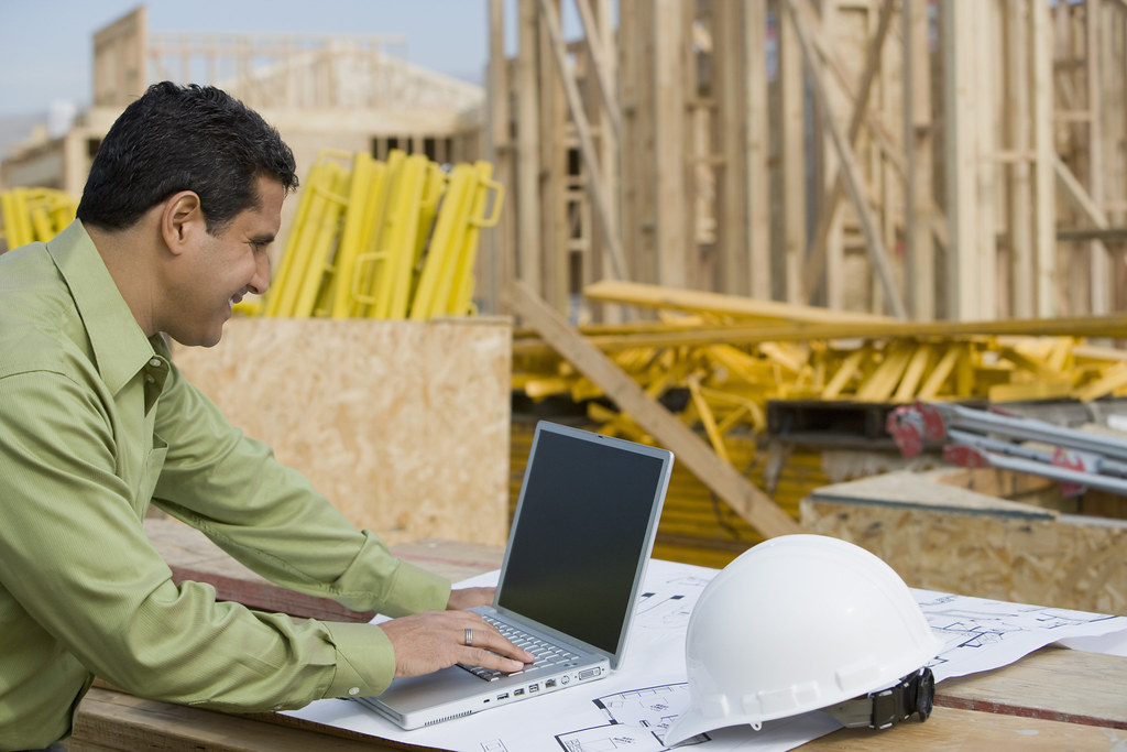 construction worker using laptop
